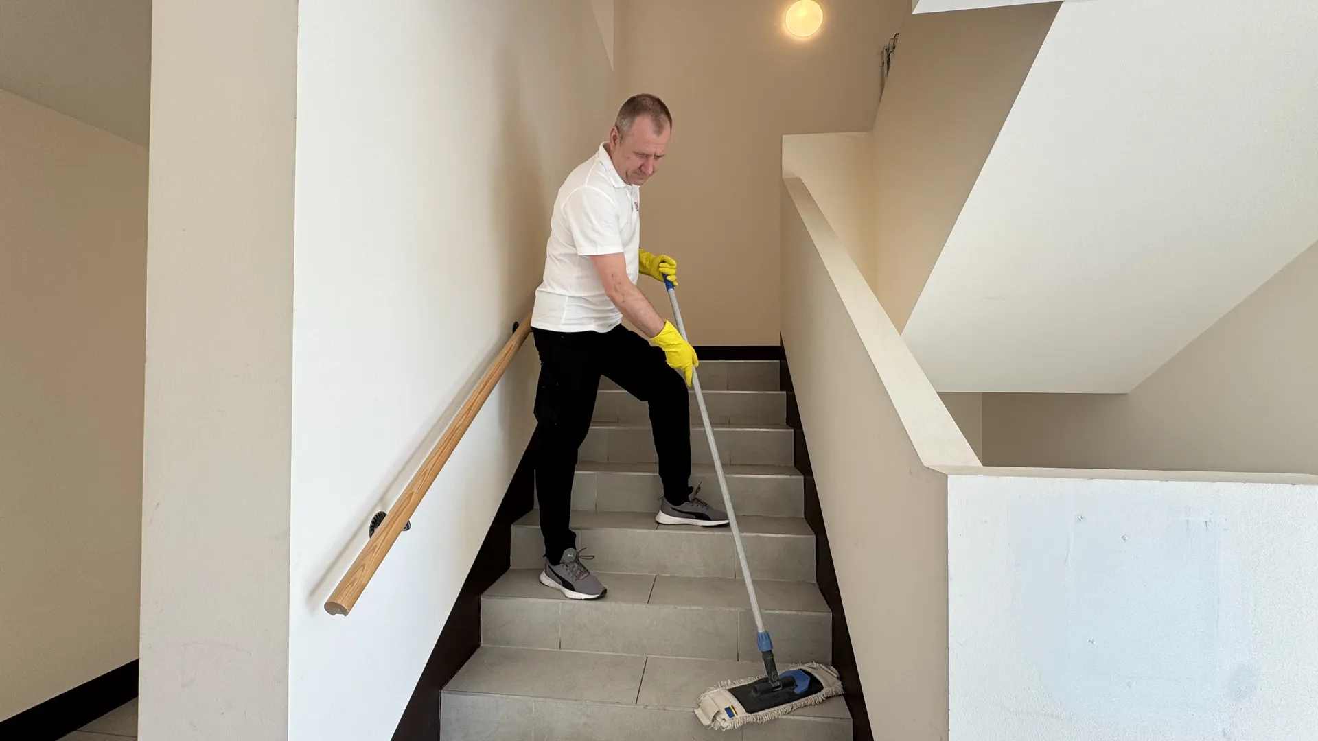 OBAU Mitarbeiter bei der feuchten Stiegenhausreinigung und Treppenpflege
